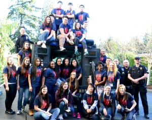 Youth from the 2015 Advancing Leadership Program pose for a photo with Federal Way police officers during an event the students hosted to foster cooperation and understanding between youth and police on Saturday at Grace Church.