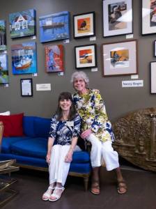 Local artists Judy Eckhardt and Nancy Bogni with their paintings displayed at the Fusion Decor Boutique in Federal Way.