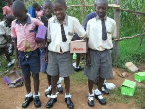 Students from Crossroads Springs school in Kenya try on shoes sent to them from students at the Federal Way Public Academy.