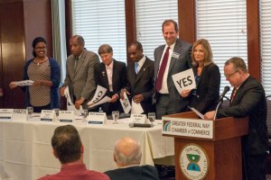 Federal Way City Council candidates hold up yes and no signs during the lightening round at the Chamber of Commerce's luncheon on Wednesday. From left to right: Lydia Assefa-Dawson (incumbent)