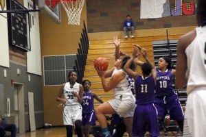 Makenzie Bond drives through a crowd of Garfield players and lays in a basket during the second half of Todd Beamer's 55-42 win on Saturday
