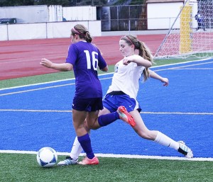 Federal Way High School sophomore Piper Hutchinson goes for the ball during the Eagles' 3-2 win over Puyallup Thursday at Federal Way Memorial Stadium.