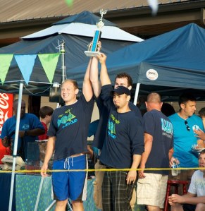 The Marine Hills swim team coaches hold up the Seattle Summer Swim League championship trophy Tuesday night. Marine Hills won a total of 20 events at the SSSL All-City Meet in Edmonds.