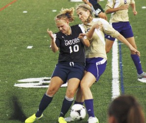 Decatur senior Victoia Braun battles with a Sumner player during the Gators’ 9-0 loss Tuesday. The Gators return several players from a team that went to the Class 3A quarterfinals last year.