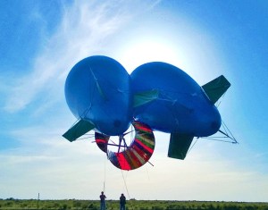 Two blimps pull a 20 foot wind turbine that turns wind into energy. The project was constructed by a Federal Way family.