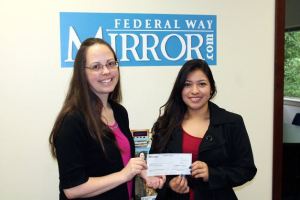Mirror Editor Carrie Rodriguez (left) presents a $500 scholarship check to Decatur senior Lizeth Saray Villarreal Garcia.