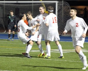 Jefferson’s Seth Walker (middle right) celebrates his go-ahead goal with teammates Justin Yoon (left)