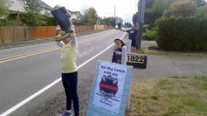 Presley Anderson holds up a boot during her fundraiser she organized last weekend to help the victims of the eastern Washington wildfires.