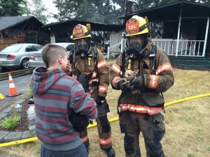 South King Fire and Rescue firefighters rescue a dog that was trapped inside a burning Federal Way home on Wednesday morning. Firefighters say the rescued dog is a hero