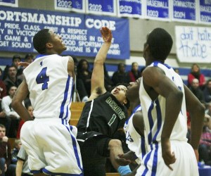 Federal Way sophomore Brayon Blake (4) blocks the shot of a Beamer player during the Eagles' win at the West Central District Tournament. Federal Way will take on Jackson at 6 p.m. Friday
