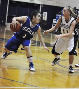 Federal Way sophomore guard Darah Huertas-Vining dribbles against an Auburn Riverside defender during Tuesday's 64-49 loss to the Ravens in Auburn. The game pitted the No. 1- and No. 2-ranked teams in the state.