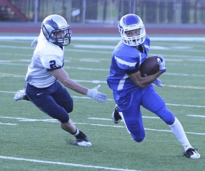 Federal Way senior running back Zeek McNeal gets around a Rogers defender Friday night during the Eagles' 41-14 win at Federal Way Memorial Stadium. McNeal scored a pair of first-half touchdowns on runs of 31 and 68 yards.