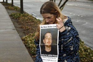 Shelly Stahl holds a poster of her son Jedidiah Waters during a vigil March 20 outside of the Regional Justice Center in Kent. Waters was shot and killed by a Federal Way police officer outside Walmart in July 2011.