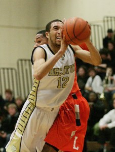 Decatur senior guard Jerron Smith attempts a shot against a Lakes defender Tuesday night in Federal Way. The Lancers won the game