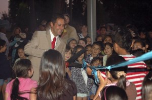 Principal Rudy Baca cuts the ribbon Wednesday night at the Sunnycrest Elementary School open house celebration. He’s surrounded by Sunnycrest students