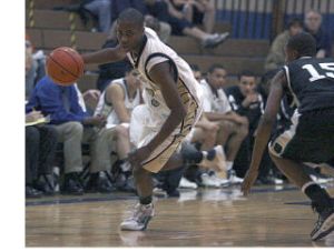 Decatur High School point guard Marcus Tibbs brings the ball up the court during the Gators’ season-opening win over Spanaway Lake Friday night