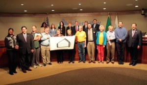 City Council and staff pose with the Federal Way Day Shelter Coalition after unanimous fund approval for the project on Tuesday.