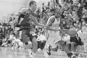 Decatur senior Marcus Tibbs dribbles by Federal Way sophomore Cole Dickerson during the 57-46 win by Decatur.