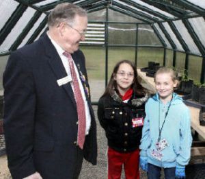 Lions Club member Bob Darrigan joins Lakeland Elementary School fourth-graders Jasmine McMillan and Kylee Mulligan-Veenker in a greenhouse at the Federal Way Senior Center.