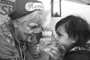 Above: Rumples the clown paints the face of Auburn resident Annika
