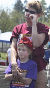 Ilima Brainard wipes a tear while she and her daughter