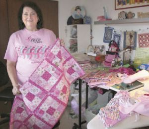 Jeri Worklan-Eubanks holds a quilt she will give to a breast cancer survivor June 21 at the Puget Sound Race for the Cure.