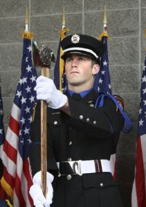 Above: A member of South King Fire and Rescue participates in the presentation of colors during the Flag Day Celebration held Saturday at the King County Aquatic Center in Federal Way. Left: Sabrina Banuelos