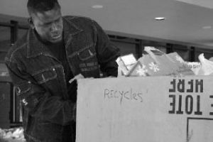 Christian Faith Center Pastor Jerry McClain helps load a carton of food onto a trailer June 16 for delivery to the Multi-Service Center/Federal Way Food Bank. Christian Faith Center delivered more than 15