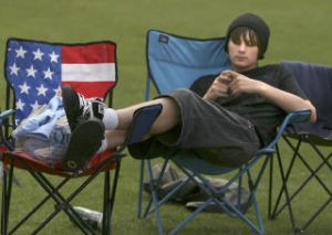 With his feet propped up on a lawn chair