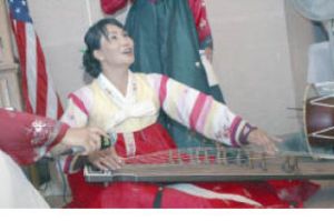 A member of the Korean-American Women’s Association of the Northwest plays a Korean harp during a performance honoring veterans on Sunday.