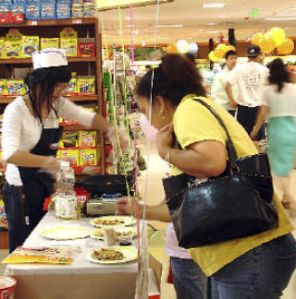 Customers at H-Mart sample traditional Asian food at the 2007 Asian Food Festival in Federal Way. Forty food vendors are expected at this year’s festivities.