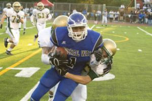 Federal Way junior wide receiver Alden Coleman is tackled by an Auburn defender Thursday night at Federal Way Memorial Stadium. Auburn won the game