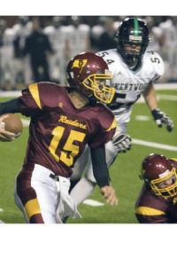 (Top) Thomas Jefferson quarterback Kama Frank (15) runs through the Kentwood defense during the Raiders’ 69-6 loss to the Conquerors Friday night.