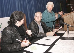 Federal Way residents Frosty and Gayla Hardison review the rules of debate with moderator Susan Kovalik on Jan. 16. The Hardisons spoke in favor of changing Federal Way's form of government to include an elected mayor.