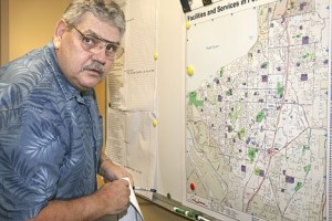 Building official Lee Bailey uses a map and colored markers during the EOC's earthquake drill March 5 to illustrate what areas of the city were suffering damage.