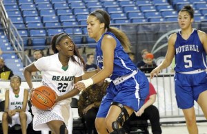 Bria Rice drives to the as Bothell’s Brenda Akoto attempts to guard her during the third and fifth place game of the 4A girls state tournament on Saturday