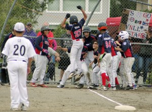 Aydan Vega leaps onto home plate after his two-run dinger. Photo by Evan Elliott.