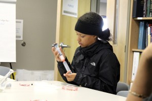 A Todd Beamer student mixes a suspension of Smarties and solution in a simulated experiment at Key Compounding on Wednesday. RAECHEL DAWSON