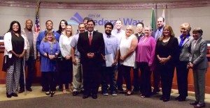 The Violence Prevention Coalition steering committee with the City Council and Mayor Jim Ferrell in August. File photo courtesy of Bruce Honda