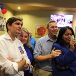 Legislative state House candidates Mike Pellicciotti, left, and Kristine Reeves, far right, react while watching King County election results come in Tuesday night. RAECHEL DAWSON, the Mirror