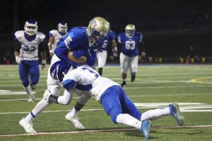 Tahoma’s Jerrel Chapman is wrapped up by Federal Way’s Bobi Sims after catching a pass in the first quarter of the Bears’ 26-22 win on Friday