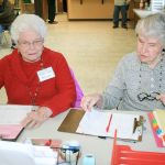 Nellie Gordon, left, and Jackie Freet prepare to receive people at the Community Caregiving Network&rsquo;s emergency services program Friday at the Church of Good Shepherd. Gordon and Freet have been volunteering in various community activities since 1969. Jessica Keller, the Mirror
