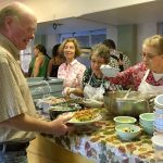 Federal Way Community Caregiving Network volunteers serve someone attending the Monday night community meal at Steel Lake Presbyterian Church. The organization is searching for another location to host the Monday night meals after board officials were told the church is being sold. Contributed photo