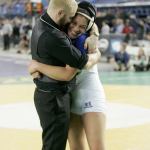 Federal Way girls wrestler Tally Thomas embraces Federal Way coach Travis Mango after winning her first state championship. Photo courtesy of Dennis Box