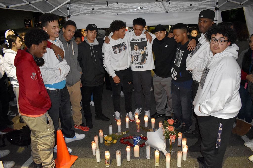 Wesley Gennings&rsquo; friends huddle around candles at a candlelight vigil on Monday night. RAECHEL DAWSON, the Mirror