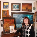 April Knight with &ldquo;Chicken Soup for the Soul: Random Acts of Kindness&rdquo; in front of her many paintings, a special hobby she has when she&rsquo;s not writing her many short stories and books. RAECHEL DAWSON, the Mirror