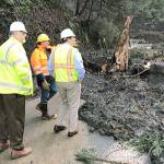Federal Way Mayor Jim Ferrell, center, surveys the aftermath of a mudslide on a section of Southwest Dash Point Road with city employees Thursday. That portion of the road has been closed and will likely not reopen until Wednesday. Photo courtesy Steve McNey
