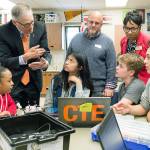 Washington Gov. Jay Inslee, standing at left, speaks with Nautilus K-8 students about Federal Way Public Schools STEM opportunities, as School Board President Geoffery McAnalloy, center, and district Superintendent Tammy Campbell look on during a tour of classrooms, April 13.                                 Contributed photo