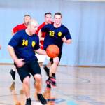 A Federal Way Police Department official dribbles the ball during a game between police and South King Fire and Rescue in 2015 at the Federal Way Community Center. File photo