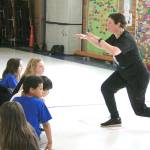 Lake Grove Elementary physical education teacher Dana Henry talks to her students before resuming activities at a Jump Rope For Heart event at the school, April 14. Henry was recently recognized by SHAPE America for her work at Lake Grove. JESSICA KELLER, the Mirror